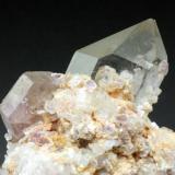 Apatite with quartz and lepidolite, Himalaya Mine. Apatite crystal is 1.5 cm across. (Author: Jesse Fisher)