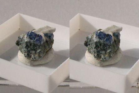 Benitoite on/in Natrolite on matrix, with minor brown grains of a Joaquinite group mineral; Dallas Gem Mine,  San Benito Co., California, USA.
Length of specimen about 15mm, Benitoite xx to 3mm. GN’s collection id 09USBnjm2.
Taken in direct sunlight.
Stereo pair. (Author: Gerhard Niklasch)
