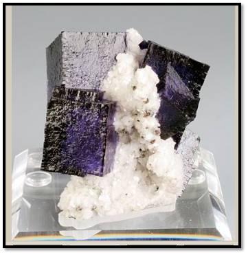 A nice combination of small dark blue/purple fluorites on sparkly dolomite from the Elmwood mine Tennessee. this piece is 6 cm tall and 5 cm wide and length. One photo is backlit. Weighs 70 grams (Author: VRigatti)