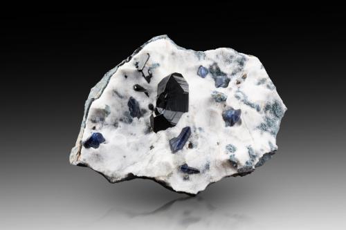 Neptunite (twinned) with Benitoite on Natrolite<br />Mina California State Gem (Benitoite Gem Mine), Zona San Benito River headwaters, Pico Santa Rita, Distrito New Idria, Condado San Benito, California, USA<br />8.5 x 6.5 x 3 cm / main crystal: 2.4 cm<br /> (Author: MIM Museum)