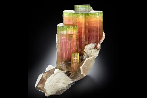 Elbaite with Orthoclase, 'lepidolite', Albite and Quartz (variety smoky)<br />Paprok, Kamdesh District, Nuristan Province, Afghanistan<br />14.5 x 12 x 16 cm / main crystal: 9.2 cm.<br /> (Author: MIM Museum)