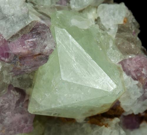 Rb-bearing Rhodizite with Elbaite (variety rubellite) and Danburite<br />Tetezantsio-Andoabatokely pegmatite field, Andrembesoa, Betafo District, Vakinankaratra Region, Madagascar<br />main crystal size: 1 × 0.8 cm<br /> (Author: Jordi Fabre)