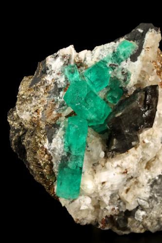 Beryl (variety emerald), Calcite, Dolomite, Pyrite<br />La Pita mining district, Cunas Mine, Municipio Maripí, Western Emerald Belt, Boyacá Department, Colombia<br />60x57x28mm, xls=20mm & 16mm<br /> (Author: Fiebre Verde)