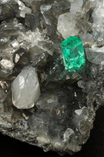 Beryl (variety emerald), Calcite, Dolomite, Pyrite, Quartz<br />La Pita mining district, Cunas Mine, Municipio Maripí, Western Emerald Belt, Boyacá Department, Colombia<br />66x49x24mm, main xl=6x4mm<br /> (Author: Fiebre Verde)