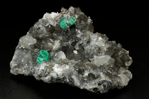 Beryl (variety emerald), Calcite, Dolomite, Pyrite, Quartz<br />La Pita mining district, Cunas Mine, Municipio Maripí, Western Emerald Belt, Boyacá Department, Colombia<br />66x49x24mm, main xl=6x4mm<br /> (Author: Fiebre Verde)