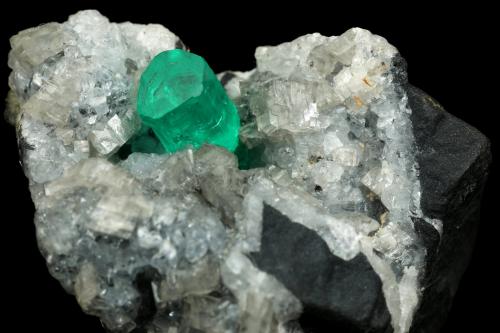 Beryl (variety emerald), Calcite, Dolomite, Pyrite<br />La Pita mining district, Polveros Mine, Municipio Maripí, Western Emerald Belt, Boyacá Department, Colombia<br />27x30x33mm, xl=9x6mm<br /> (Author: Fiebre Verde)