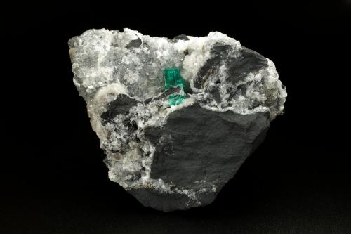Beryl (variety emerald), Calcite, Pyrite<br />Coscuez (distrito minero), Municipio San Pablo de Borbur, Cinturón Esmeraldífero Occidental, Departamento Boyacá, Colombia<br />70x65x43mm, xl=12mm<br /> (Author: Fiebre Verde)