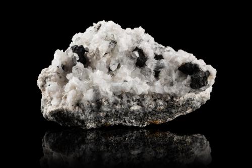 Sellaite with Calcite and Jalpaite<br />Huanzala Mine, Huallanca District, Dos de Mayo Province, Huánuco Department, Peru<br />14,0	x	9,0	x	7,0	cm<br /> (Author: MIM Museum)