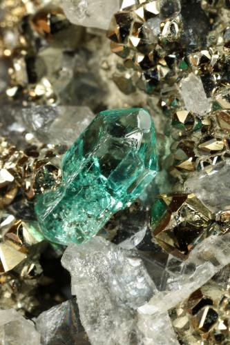 Beryl (variety emerald), Calcite, Pyrite<br />Chivor mining district, El Acuario Mine, Municipio Chivor, Eastern Emerald Belt, Boyacá Department, Colombia<br />33x41x21mm, xl=8mm<br /> (Author: Fiebre Verde)