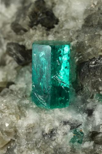 Beryl (variety emerald), Calcite, Dolomite<br />La Pita mining district, Cunas Mine, Municipio Maripí, Western Emerald Belt, Boyacá Department, Colombia<br />38x58x47mm, xl=9mm<br /> (Author: Fiebre Verde)