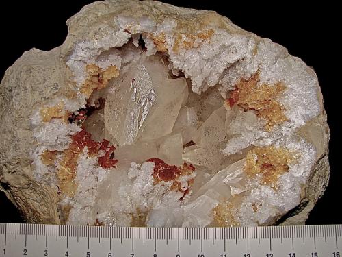 Calcite with Marcasite inclusions on Dolomite and Quartz<br />State Route 37 road cuts, Harrodsburg, Clear Creek Township, Monroe County, Indiana, USA<br />geode is about 14 cm,  cavity is about 10 cm, largest calcite is about 4.5 cm<br /> (Author: Bob Harman)