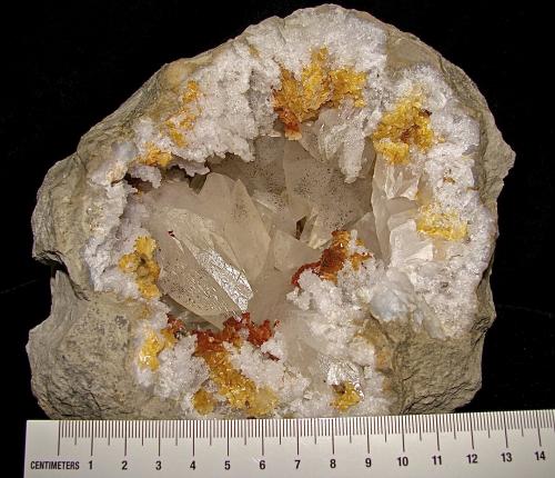 Calcite with Marcasite inclusions on Dolomite and Quartz<br />Afloramientos Carretera Estatal 37, Harrodsburg, Clear Creek, Condado Monroe, Indiana, USA<br />geode is about 14 cm,  cavity is about 10 cm, largest calcite is about 4.5 cm<br /> (Author: Bob Harman)