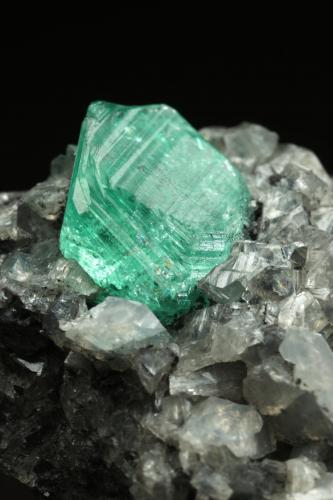 Beryl (variety emerald), Calcite, Dolomite<br />La Pita mining district, Municipio Maripí, Western Emerald Belt, Boyacá Department, Colombia<br />39x24x18mm, xl=9mm<br /> (Author: Fiebre Verde)