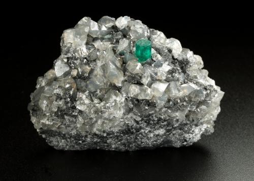 Beryl (variety emerald), Calcite, Dolomite<br />La Pita mining district, Municipio Maripí, Western Emerald Belt, Boyacá Department, Colombia<br />53x38x34mm, xl=5x4mm<br /> (Author: Fiebre Verde)