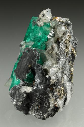 Beryl (variety emerald), Calcite, Pyrite<br />Coscuez mining district, Calceteros Mine, Municipio San Pablo de Borbur, Western Emerald Belt, Boyacá Department, Colombia<br />29x45x27mm, xl=34mm<br /> (Author: Fiebre Verde)