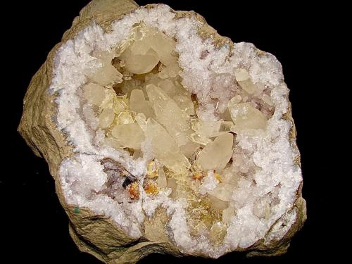 Calcite, Barite and Dolomite on Quartz<br />State Route 37 road cuts, Harrodsburg, Clear Creek Township, Monroe County, Indiana, USA<br />geode is 22 cm x 18 cm. The largest doubly terminated calcite (near the cavity center) is 7 cm<br /> (Author: Bob Harman)