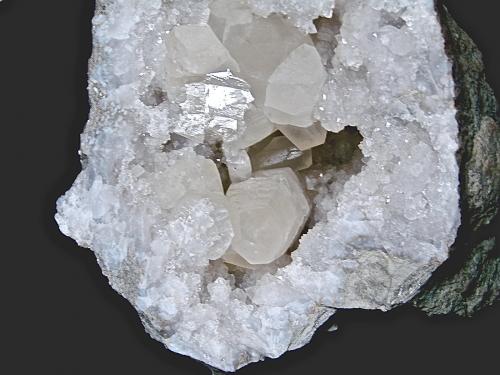 Calcite on Quartz<br />State Route 37 road cuts, Harrodsburg, Clear Creek Township, Monroe County, Indiana, USA<br />the largest intact calcite, seen on end at the 6 o''clock position, in this picture is 7.0 cm<br /> (Author: Bob Harman)