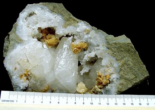 Calcite and Dolomite on Quartz<br />State Route 37 road cuts, Harrodsburg, Clear Creek Township, Monroe County, Indiana, USA<br />geode is 13 cm, the calcite is 4.2 cm and the dolomite groups are up to 2.6 cm<br /> (Author: Bob Harman)