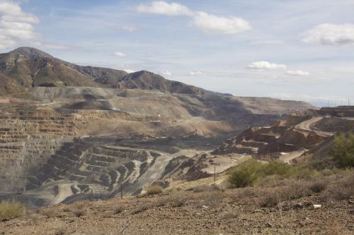 _At the far left bottom, you can just make out a 400 ton, Lieberr T282B haul truck, the size of a two story house, moving it’s load at a walking speed toward the primary crusher. (Author: vic rzonca)