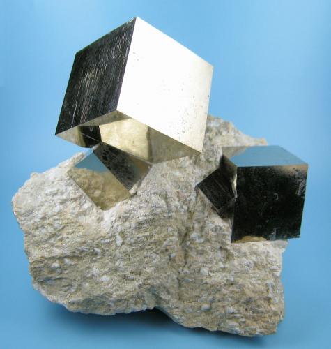 Four undamaged cubic pyrite crystals with mirror-like faces intergrown on a matrix of marlstone (some people claim it to actually be limolite). Field collected in spring 2007. (Author: Carles Millan)