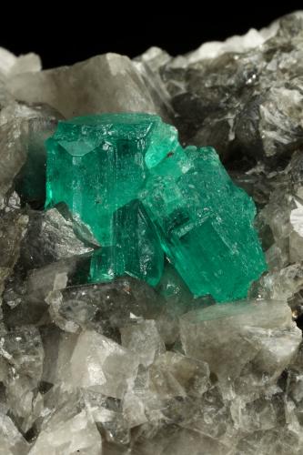 Beryl (variety emerald), Calcite, Dolomite<br />Muzo mining district, Western Emerald Belt, Boyacá Department, Colombia<br />79x49x66mm, largest xl=13x9mm<br /> (Author: Fiebre Verde)