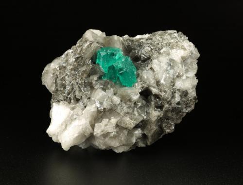 Beryl (variety emerald), Calcite, Dolomite<br />Muzo mining district, Western Emerald Belt, Boyacá Department, Colombia<br />79x49x66mm, largest xl=13x9mm<br /> (Author: Fiebre Verde)