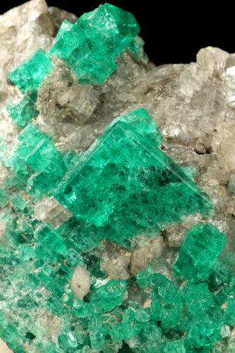 Beryl (variety emerald), Calcite, Muscovite<br />La Pita mining district, Cunas Mine, Municipio Maripí, Western Emerald Belt, Boyacá Department, Colombia<br />40x63x47mm, largest xl=14x11mm<br /> (Author: Fiebre Verde)