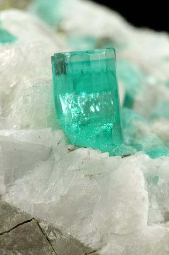 Beryl (variety emerald), Calcite, Pyrite<br />Chivor mining district, El Oriente Mine, Municipio Chivor, Eastern Emerald Belt, Boyacá Department, Colombia<br />59x50x33mm, xl=8mm<br /> (Author: Fiebre Verde)