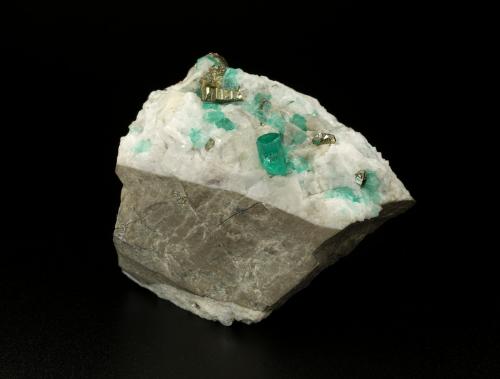 Beryl (variety emerald), Calcite, Pyrite<br />Chivor mining district, El Oriente Mine, Municipio Chivor, Eastern Emerald Belt, Boyacá Department, Colombia<br />59x50x33mm, xl=8mm<br /> (Author: Fiebre Verde)