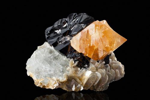 Scheelite on Cassiterite with Muscovite and Beryl (variety goshenite)<br />Mount Xuebaoding, Pingwu, Mianyang Prefecture, Sichuan Province, China<br />7.0 x 6.5 x 4.5 cm<br /> (Author: MIM Museum)