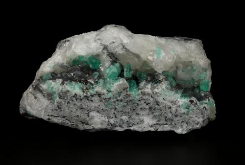 Beryl (variety emerald), Calcite, Pyrite<br />Coscuez (distrito minero), Municipio San Pablo de Borbur, Cinturón Esmeraldífero Occidental, Departamento Boyacá, Colombia<br />122x65x48mm, xls up to 8mm<br /> (Author: Fiebre Verde)