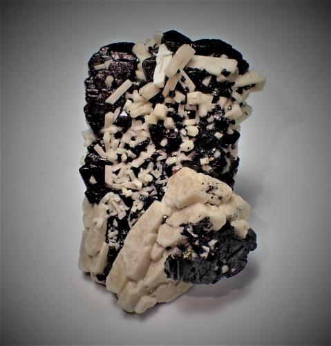 Magnetite (variety Ti-bearing), Microcline<br />Imilchil area, Anti-Atlas, Er Rachidia Province, Drâa-Tafilalet Region, Morocco<br />53 mm x 39 mm x 22 mm<br /> (Author: Don Lum)