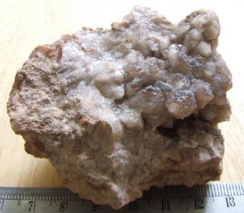 This is a  "Somerset Potato" The farmers turn them up in the fields of Somerset and when they are covered in mud they look like Potatoes, They contain Calcite, Quartz and sometimes Amethyst. (Author: nurbo)
