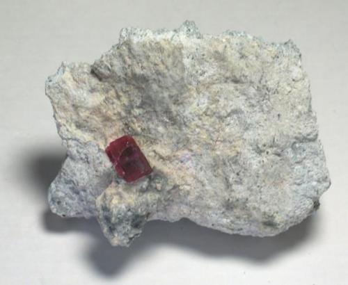 Red Beryl. Utah.  Beryl is gemmy with lots of cutting windows -- if one could even contemplate such a thing.  10.8 x 7.8 x 4.2 cm overall.  1.6 x 1.2 x 1.2 cm crystal. (Author: GneissWare)