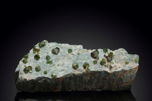 Andradite (variety demantoid)<br />Sferlùn asbestos Mine, Vallone del Cengiaccio, Lanzada, Malenco Valley (Valmalenco), Sondrio Province, Lombardy, Italy<br />19.5 x 7 x 5.5 cm / main crystal: 1.4 cm<br /> (Author: MIM Museum)