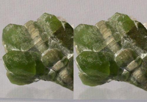 Olivine series, Forsterite var.Peridot with Calcite; Sapat Gali (Soppat), Kohistan, Pakistan.
50x35x33mm, 56g. GN’s collection id 09PKOcm01.
Taken in direct sunlight. Stereo pair. (Author: Gerhard Niklasch)
