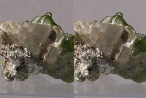 Olivine series, Forsterite var.Peridot with Calcite; Sapat Gali (Soppat), Kohistan, Pakistan.
50x35x33mm, 56g. GN’s collection id 09PKOcm01.
Taken in direct sunlight. Stereo pair. (Author: Gerhard Niklasch)