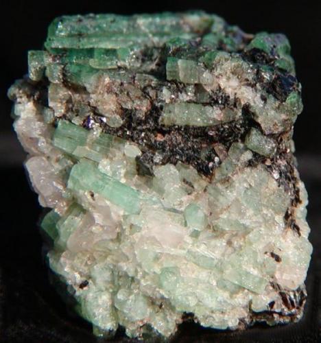 Emeralds in Biotite Schist. 
Cobra Pit, Gravelotte Emerald Mine, Limpopo Province, S. Africa
2.7 x 2.3 x 2.5cm
Crystals to 1.6cm (Author: Debbie Woolf)