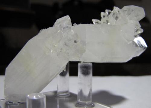 Two large, opaque fluorapophyllite crystals (and a third, smaller one) stuck together at a strange angle with smalller crystals attached and covered by scattered stilbite bowties about 2 mm long.  From Jalgaon, Maharashtra, India.  Approx. 92 x 36 x 30 mm. (Author: Tracy)