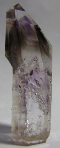 Quartz "half-scepter" with smoky and amethyst phantoms, from Goboboseb, Namibia, 6.2 x 2.3 x 1.9 cm.  Ex. C. Key Collection.  I’m following John’s "scepters" thread trying to figure out what conditions would exist to create a crystal like this... (Author: Tracy)