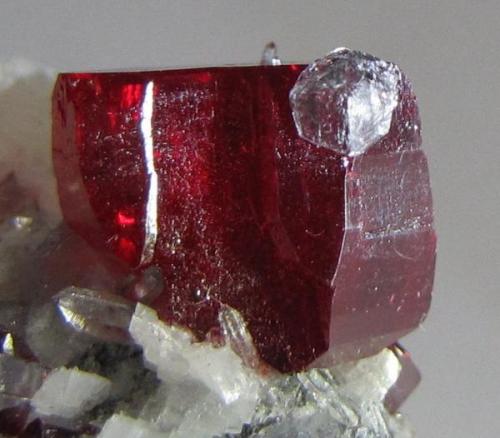 Back side of crystal.  Not sure about the mineral attached to its edge, quartz maybe? (Author: Tracy)