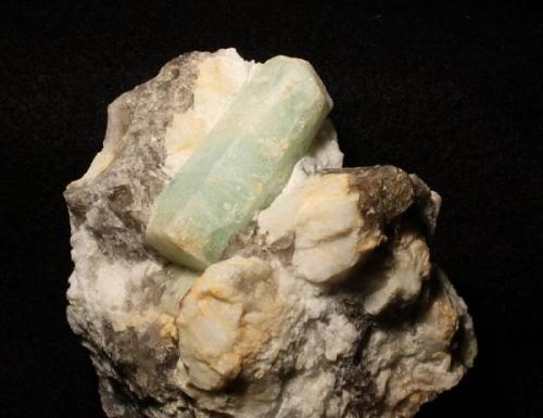 Aquamarine on smokey quartz with feldspar from Tripp Mine, Alstead, New Hampshire. Crystal is 5 cm long. (Author: Jessica Simonoff)