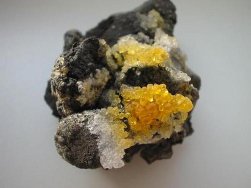 Little yellow sal ammoniac crystals on "fried" conglomerate from the Alstaden coal mine, Oberhausen, Westphalia. Here gorgeous sceleton-crystals up to 3,5 cm were found but till I will get such a killer I make do with the shown one... (Author: Andreas Gerstenberg)