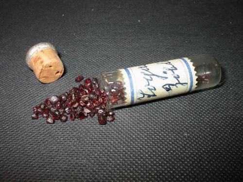 Old vial with rounded pyrope crystals ("Bohemian Garnet") from Zöblitz, Erzgebirge, Saxony, a famous pyrope locality. (Author: Andreas Gerstenberg)