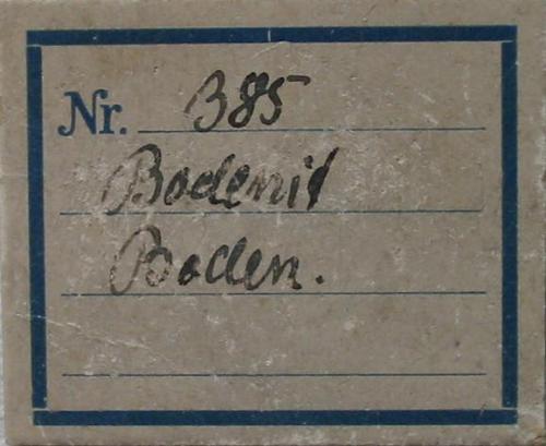 Bodenite is a variety of allanite-(Y). Label from 1926. From type locality Boden limestone deposit, near Marienberg, Saxony. (Author: Andreas Gerstenberg)