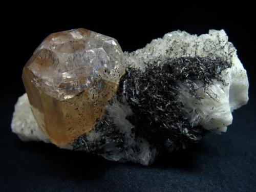 On a matrix of cleavelandite stands a stunning prismatic, peach coloured topaz measuring 28mm x 29mm and 40mm tall. from Pakistan, Northern Areas, Skardu, Yunu, Shigar Valley

Size 100 x 50 x 58 mm (Author: olelukoe)