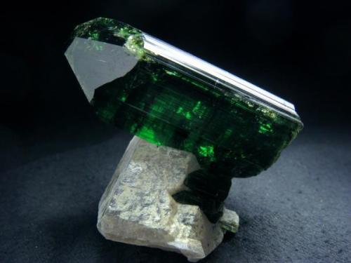 Deepest green coloure tourmaline (var. Verdelite, main crystal size 62 x 30 x 22 mm) crystal, that sitting on quartz crystal, from Pederneira claim, Sao Jose da Safira, Doce valley, Minas Gerais, Southeast Region, Brazil

Size 62 x 45 x 51 mm (Author: olelukoe)