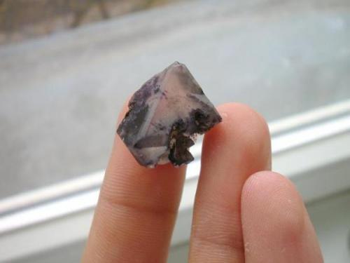 Pale violet fluorite octahedron from the Arnsdorf granite quarries, Königshainer Berge near Görlitz, Oberlausitz, Saxony. Although fluorites often occur in granite deposits (think of Strzegom/Poland), at this very location fluorite is a rarity. In the literature you´ll find marginal notes concerning little green or violet aggregates - not as good as the famous smoky quartzes from here. The shown crystal is part of a find some couple of years ago which developed a few single crystals and two or three matrix samples. Most of them were bought by the Bergakademie Freiberg. (Author: Andreas Gerstenberg)