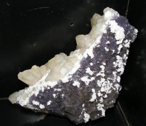 Fluorita morada (muy rara en la mina Moscona), con dolomita blanca, cristales de calcita y barita amarilla. La pieza mide unos 20cm. (Autor: yowanni)
