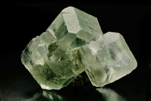 Fluorita, de delicada tonalidad verde, procedente de la zona minera de Xianghualing-Xianghuapu, en cuyos cristales   se observan claramente las formas {100} cubo y  {110} Rombododecaedro, característicos también de yacimientos asturianos tan significativos como los de la Collada, Arista del cubo 5 cm.
Foto: J. R. García (Autor: JRG)